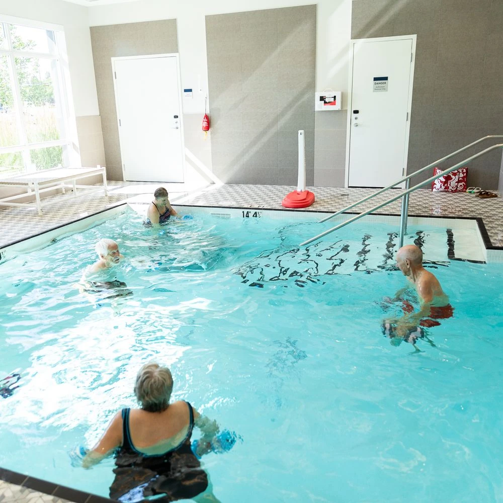 Seniors enjoying the pool at Aster Gardens together