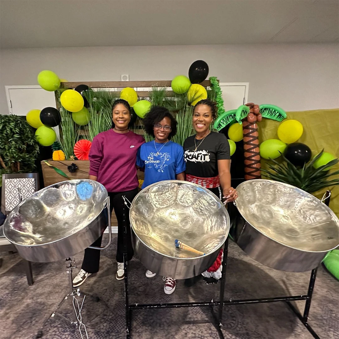 Women standing behind pan drums
